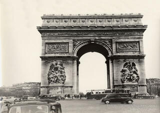The grand Arc de Triomphe in Paris, France, massive stone monument with sculpted reliefs and central archway, standing at the center of Place Charles‑de‑Gaulle