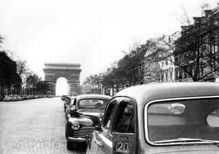 The Arc de Triomphe de l'Etoile is a massive neoclassical triumphal arch in the heart the city of Paris, with an open central vault and the names of soldiers.