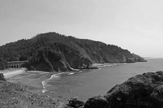 Devil’s Elbow State Park on Oregon’s coast, featuring historic Heceta Head Lighthouse, rugged cliffs, lush forest, rocky shoreline, and Pacific waves.
