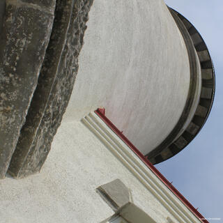 Heceta Head Lighthouse on the Oregon Coast, standing high above the Pacific Ocean with rugged cliffs and forested coastal scenery