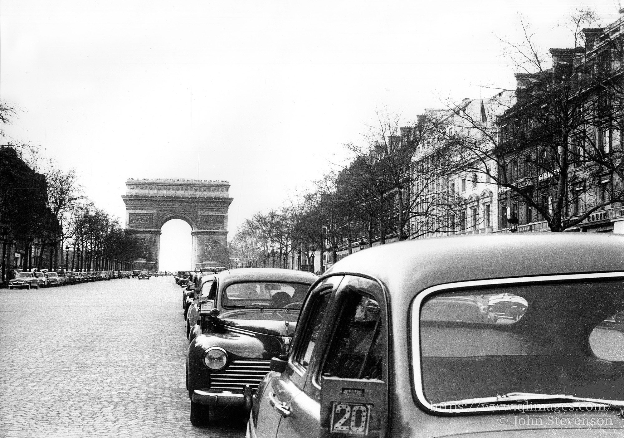 The Arc de Triomphe de l'Etoile is a massive neoclassical triumphal arch in the heart the city of Paris, with an open central vault and the names of soldiers.